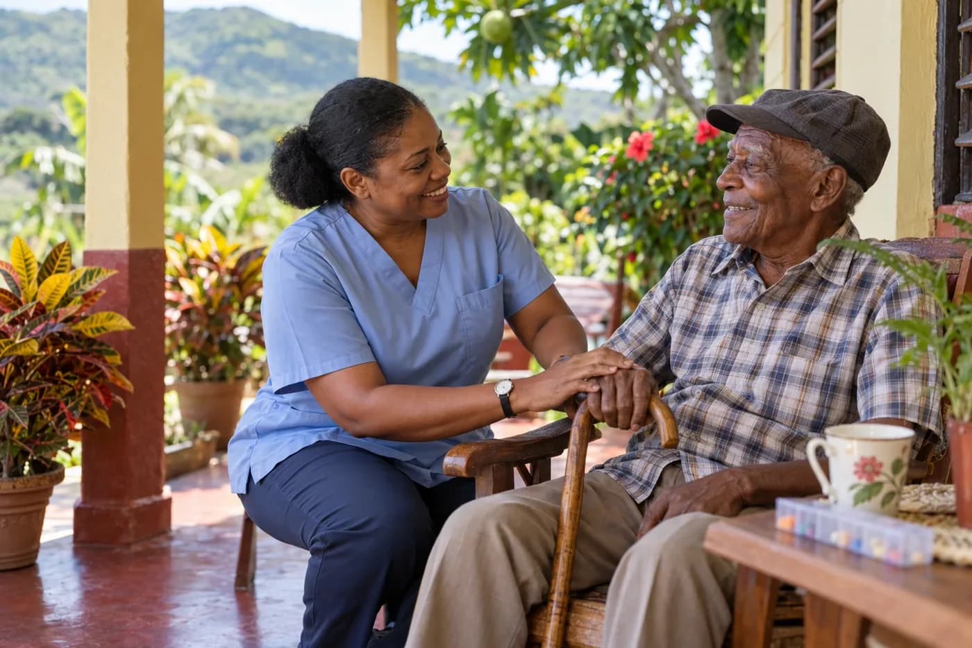 A caregiver sitting with an elderly man on a verandah in Jamaica — illustrative.